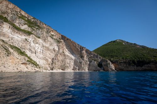 Free Beautiful coastal cliffs with turquoise water and clear sky, perfect for summer travel inspiration. Stock Photo