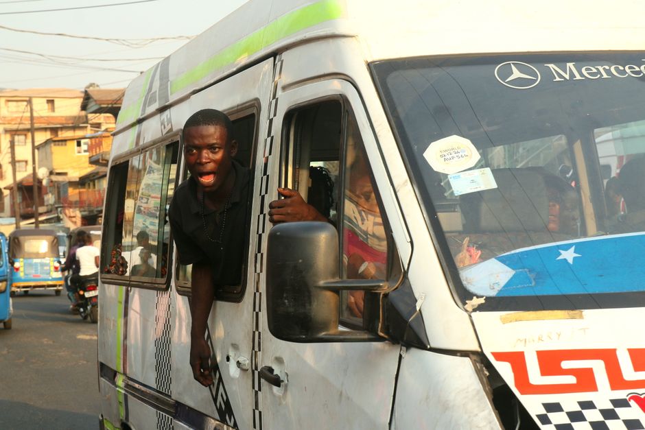 Energetic passengers in a minibus add vibrancy to daily life in Freetown.