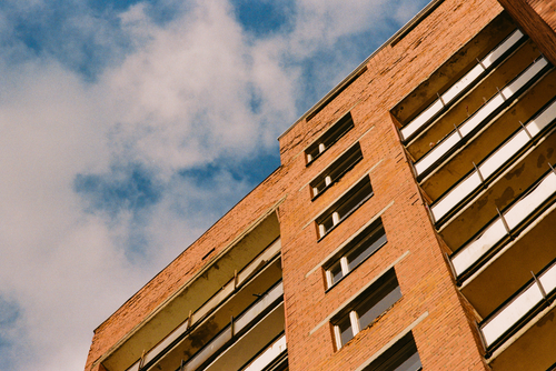 Free A brick building facade under a bright blue sky in Riga, Latvia. Capturing urban architecture. Stock Photo