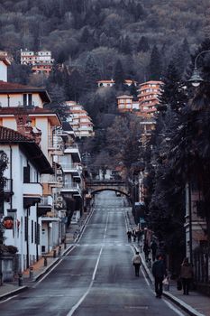 Picturesque street in an Alpine town during winter, showcasing quaint architecture and a serene atmosphere.
