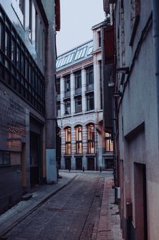 A serene alley through historic urban buildings at dusk, capturing architectural elegance.