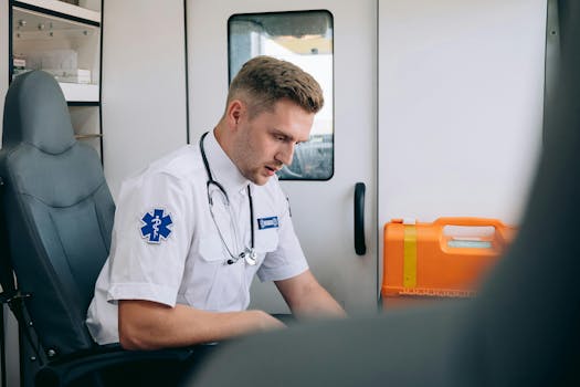 Focused paramedic in an ambulance setting, wearing uniform and stethoscope, ready for emergency response.