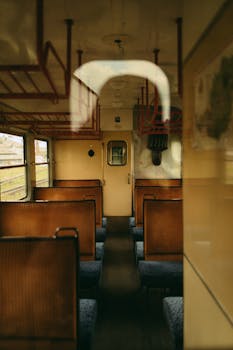 Explore a vintage train interior showcasing wood seats and retro design elements.