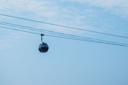 Free Aerial view of a cable car suspended against a clear blue sky in Jakarta, Indonesia. Stock Photo