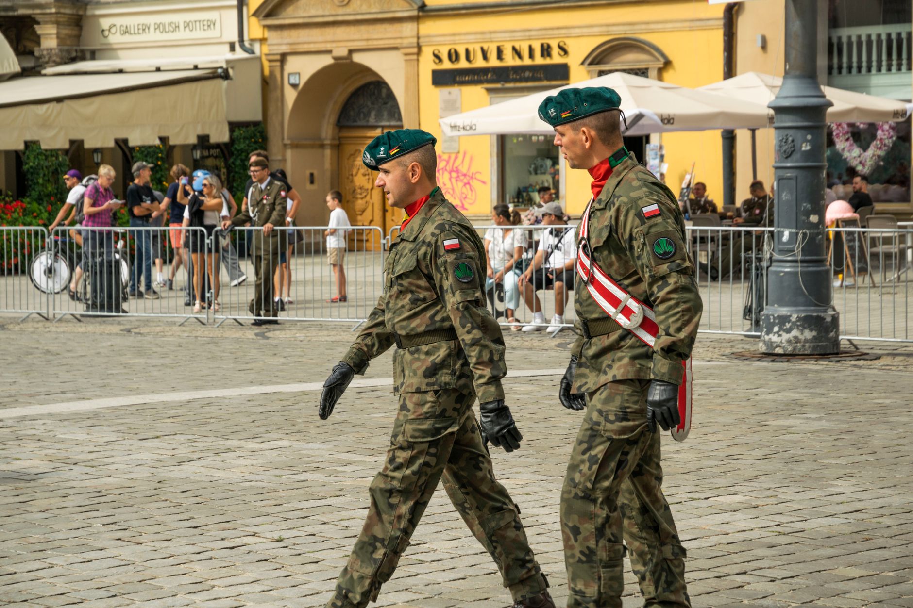 Polish soldiers in military attire march during a parade in Wrocław, capturing a moment of national pride.