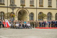 Polish military ceremony in Wrocław with flags and uniformed personnel.