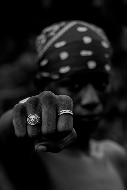 Free Expressive black and white portrait showcasing a fist adorned with rings, symbolizing strength and individuality. Stock Photo
