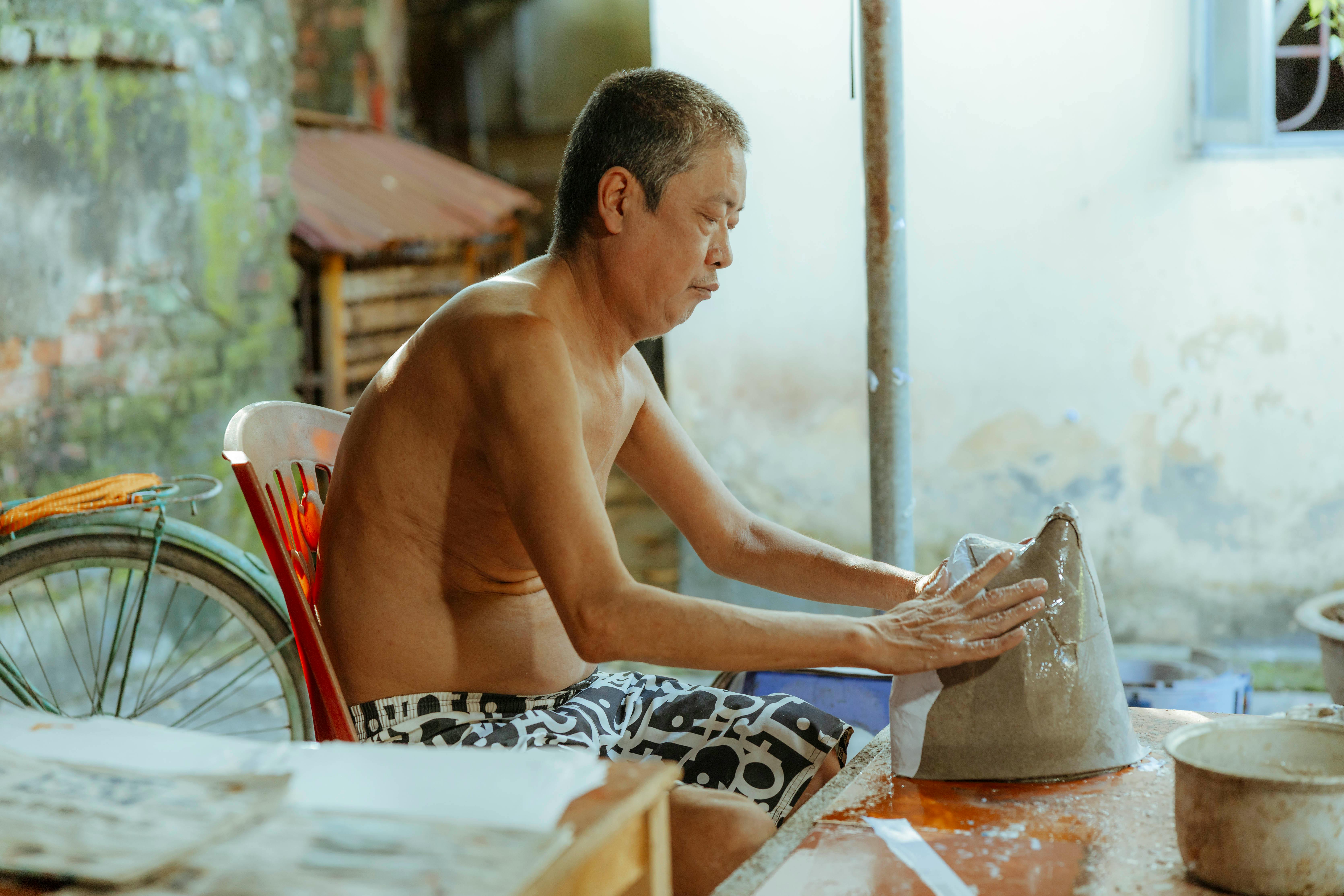 a man is making a pottery bowl