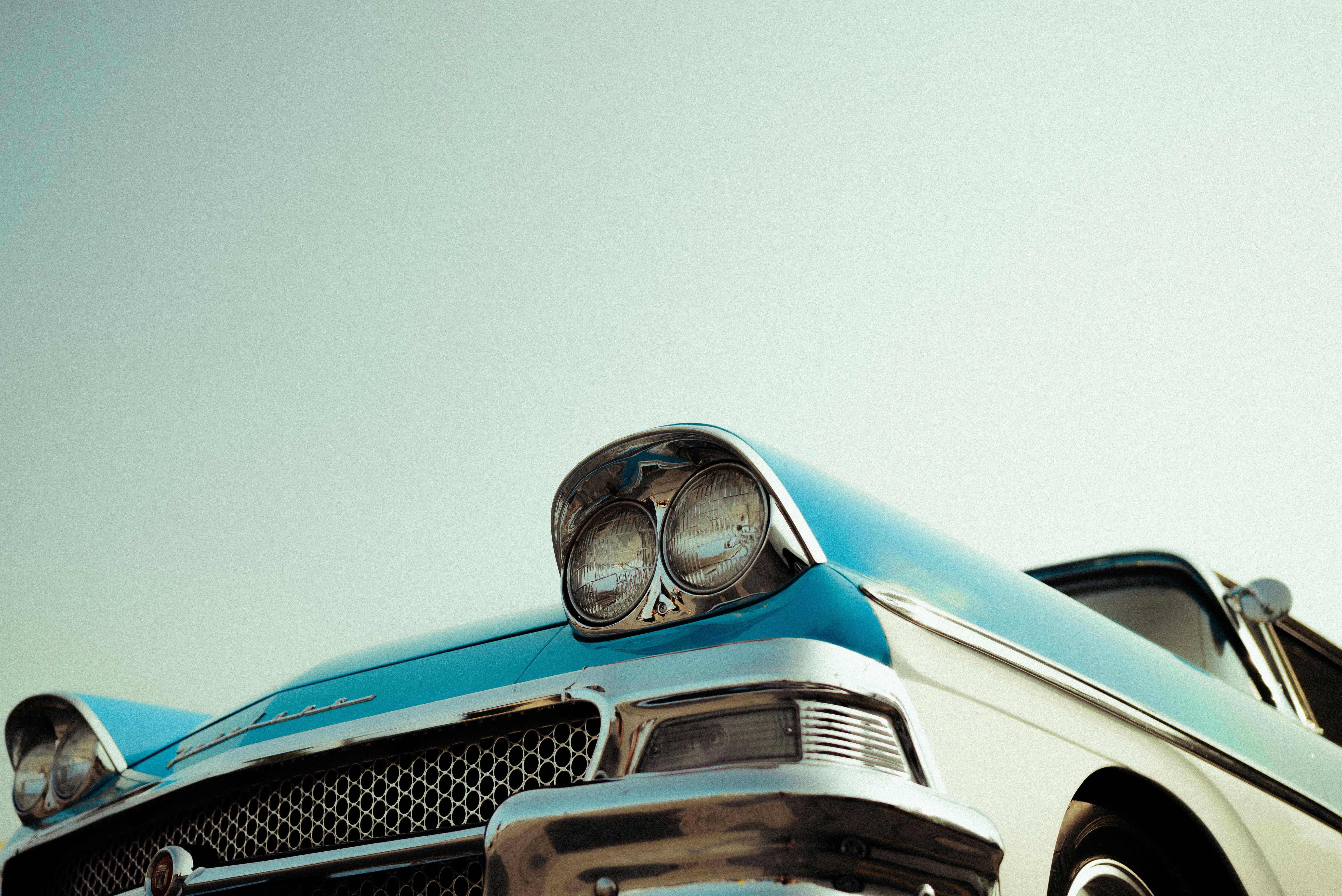 Close-up of a vintage blue classic car showcasing chrome details and retro style.