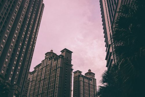 Free Stunning view of Jakarta skyline with tall modern buildings against a pink sunset sky. Stock Photo