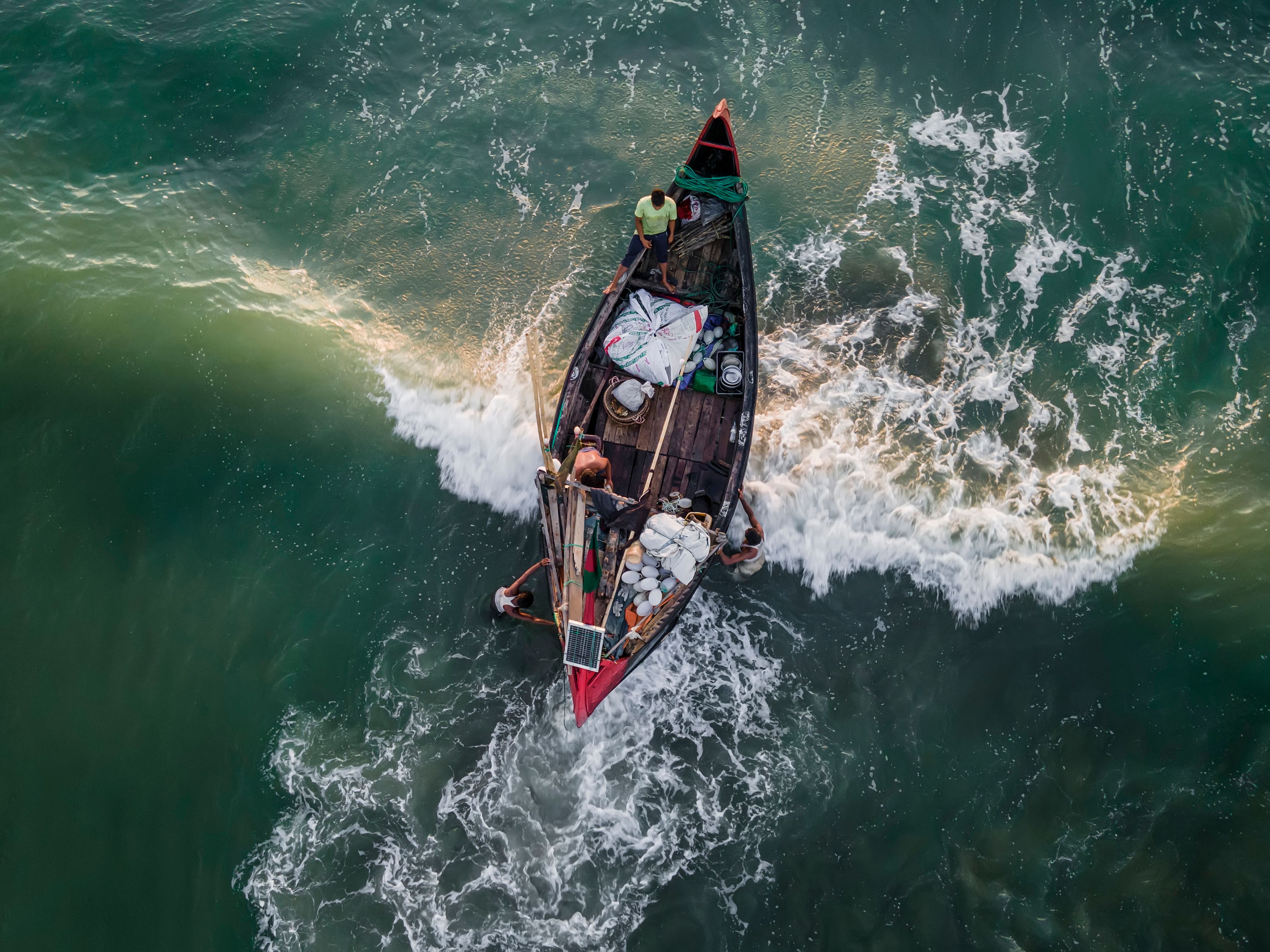 An aerial view of a small boat in the ocean · Free Stock Photo