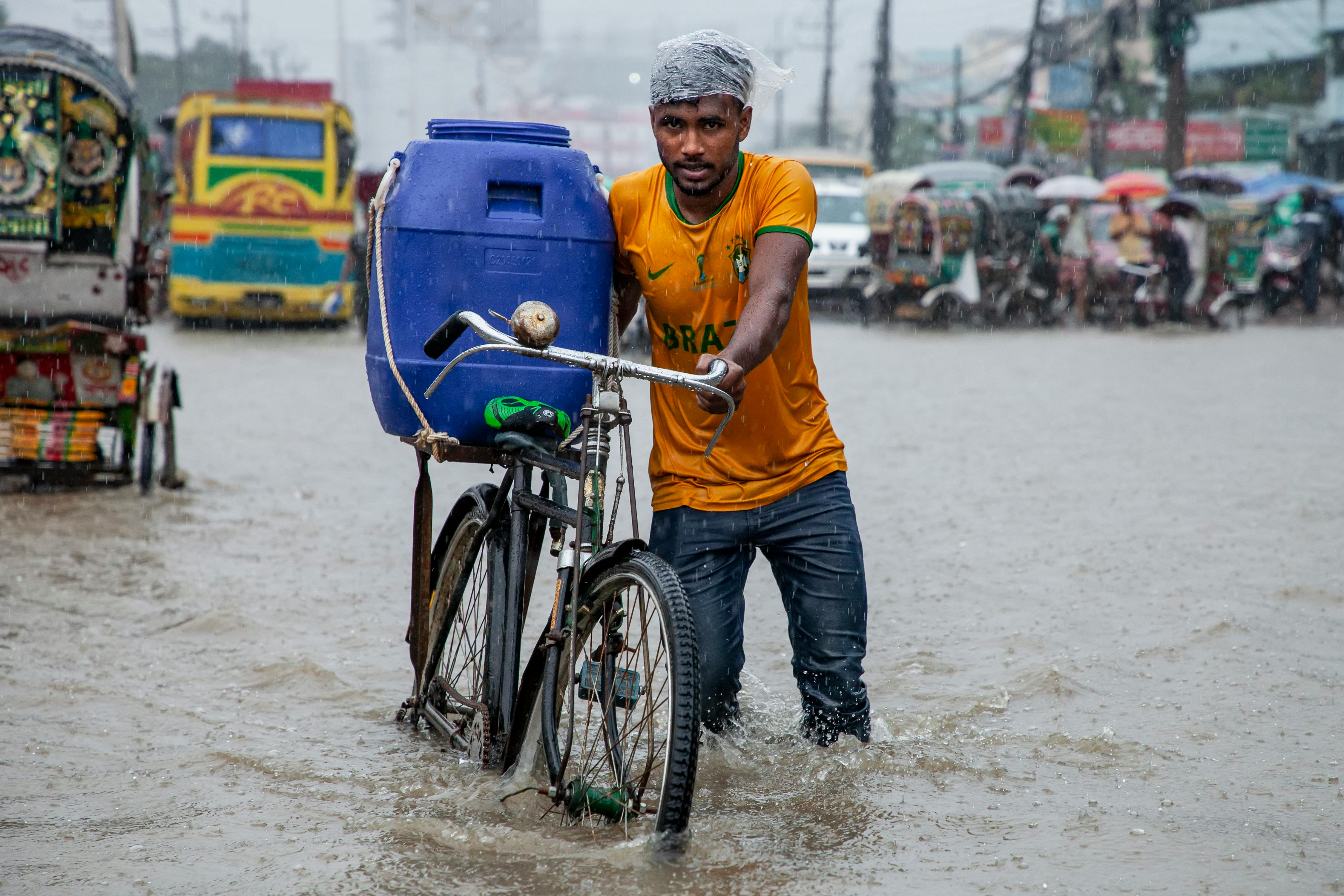 a man on a bicycle with a blue water container