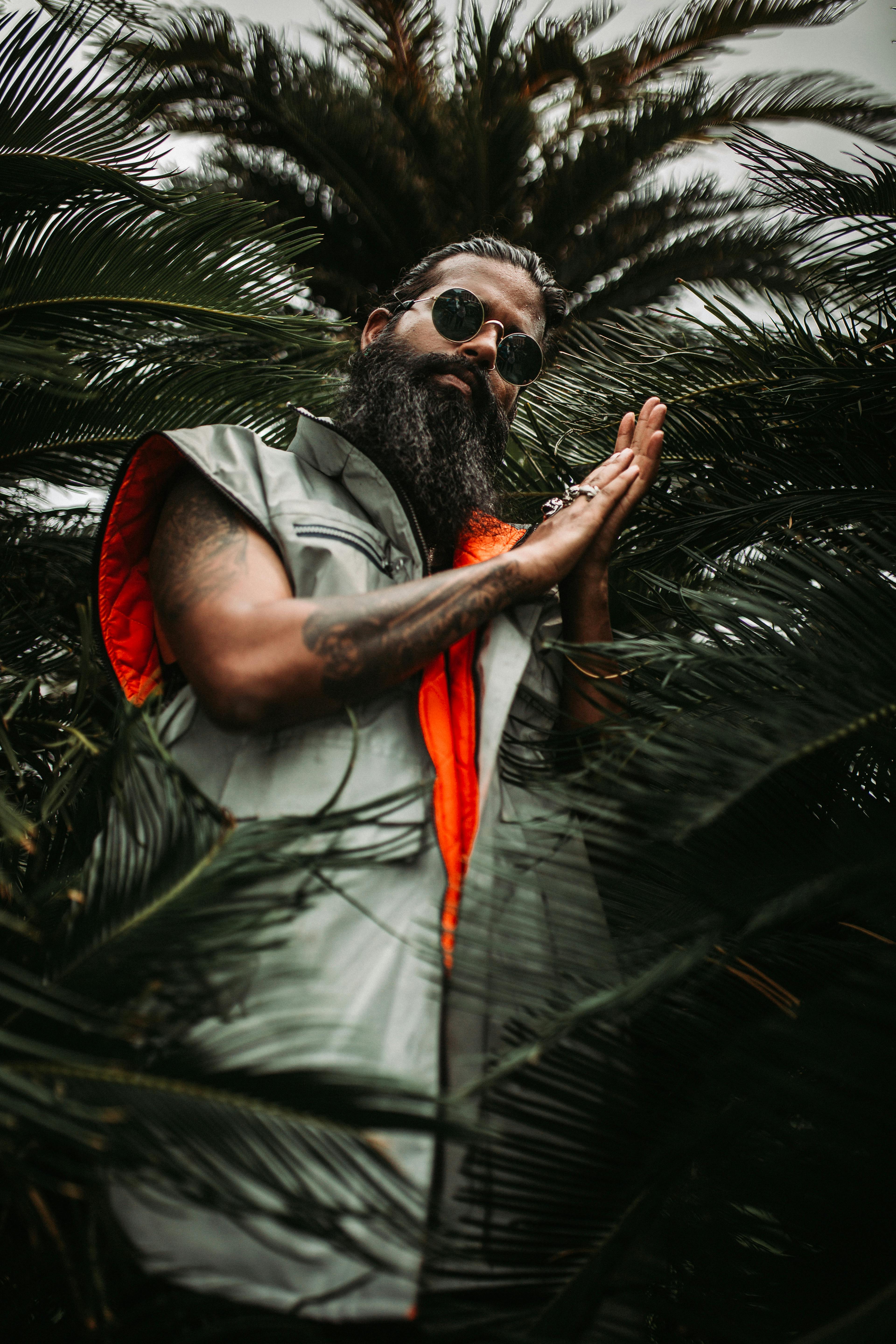 Kostenlos Low Angle Foto Des Mannes, Der Nahe Palmenpflanzen Steht Stock-Foto