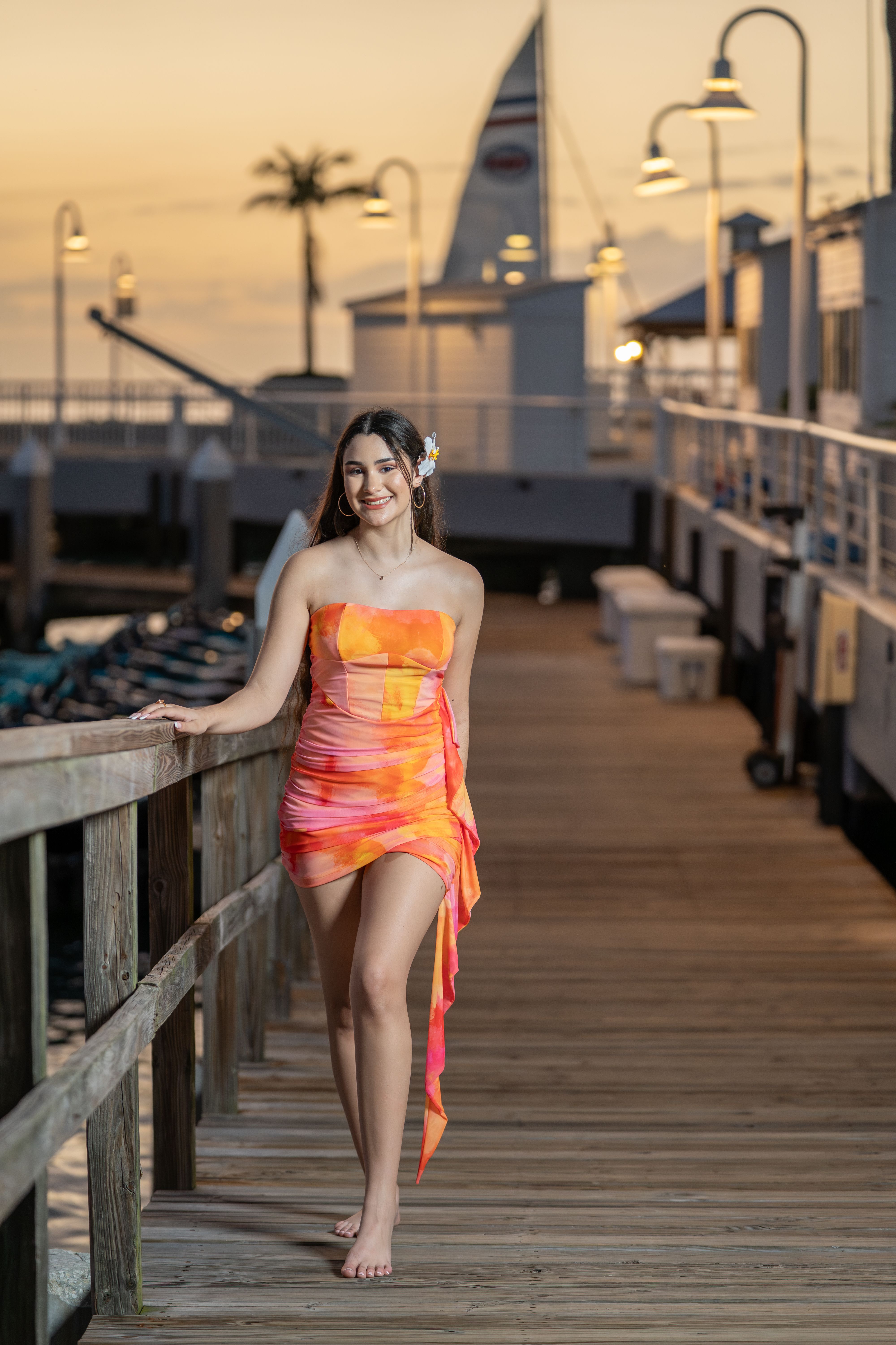 A woman in a dress standing on a pier · Free Stock Photo