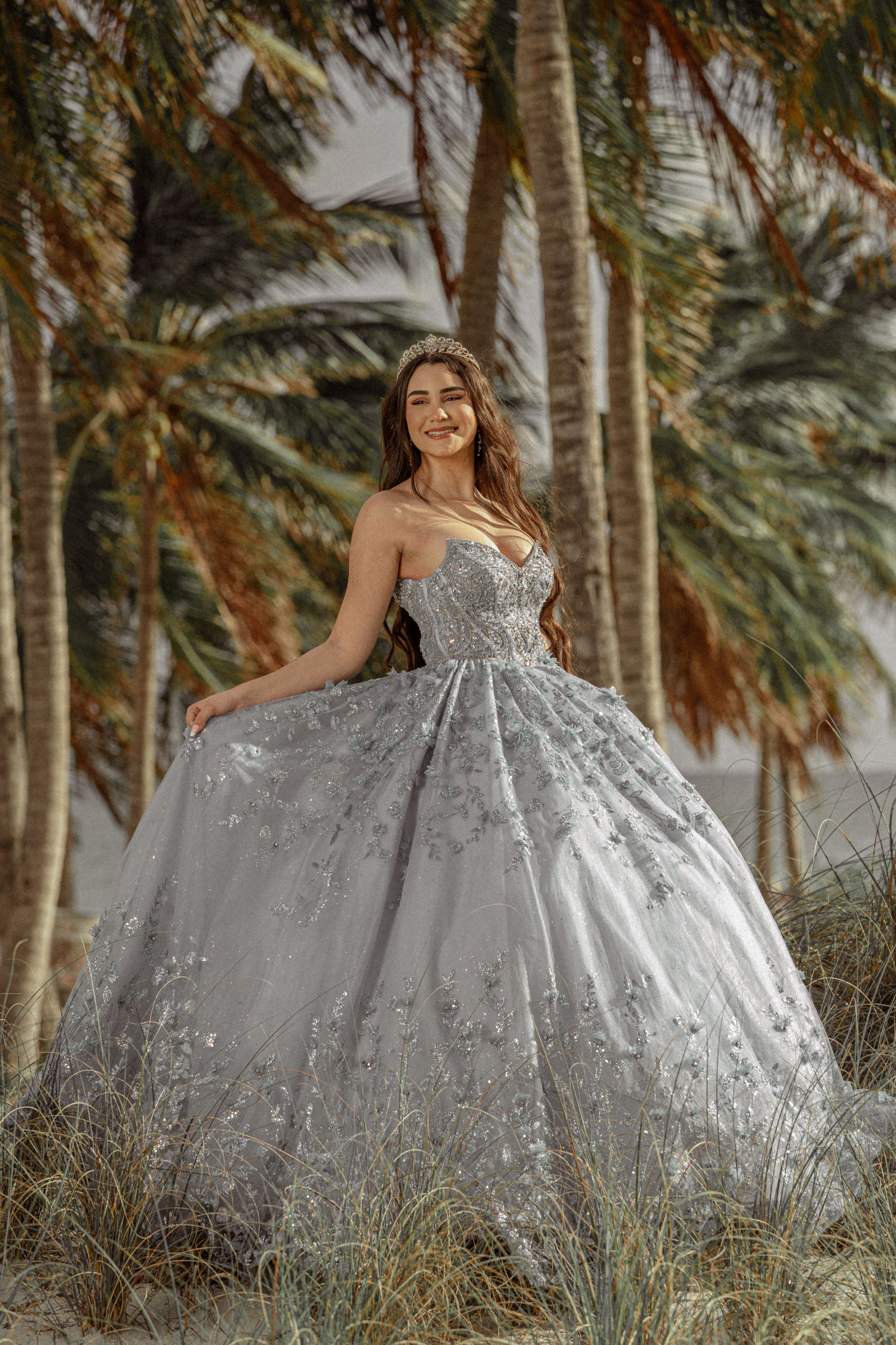 A beautiful woman in a blue ball gown posing on the beach · Free Stock ...
