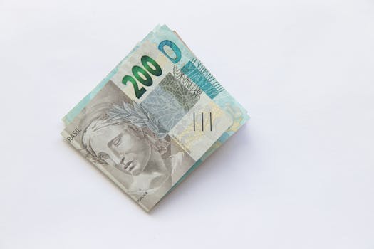 Stack of 200 Brazilian Real banknotes isolated on a white surface, symbolizing wealth and finance.