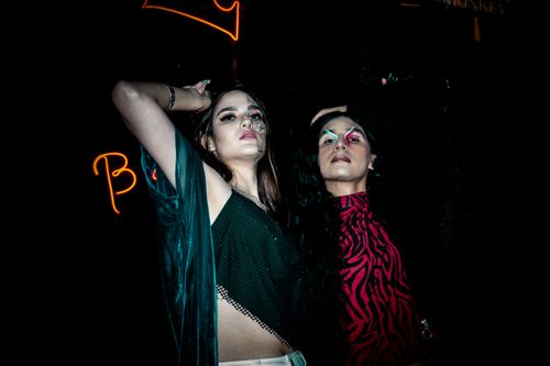 Free Two fashionable adults embracing nightlife in Naucalpan de Juárez, Mexico. Vibrant and dramatic style. Stock Photo