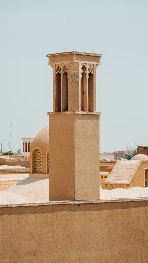 Free Ancient wind tower and dome in a traditional Middle Eastern cityscape. Stock Photo