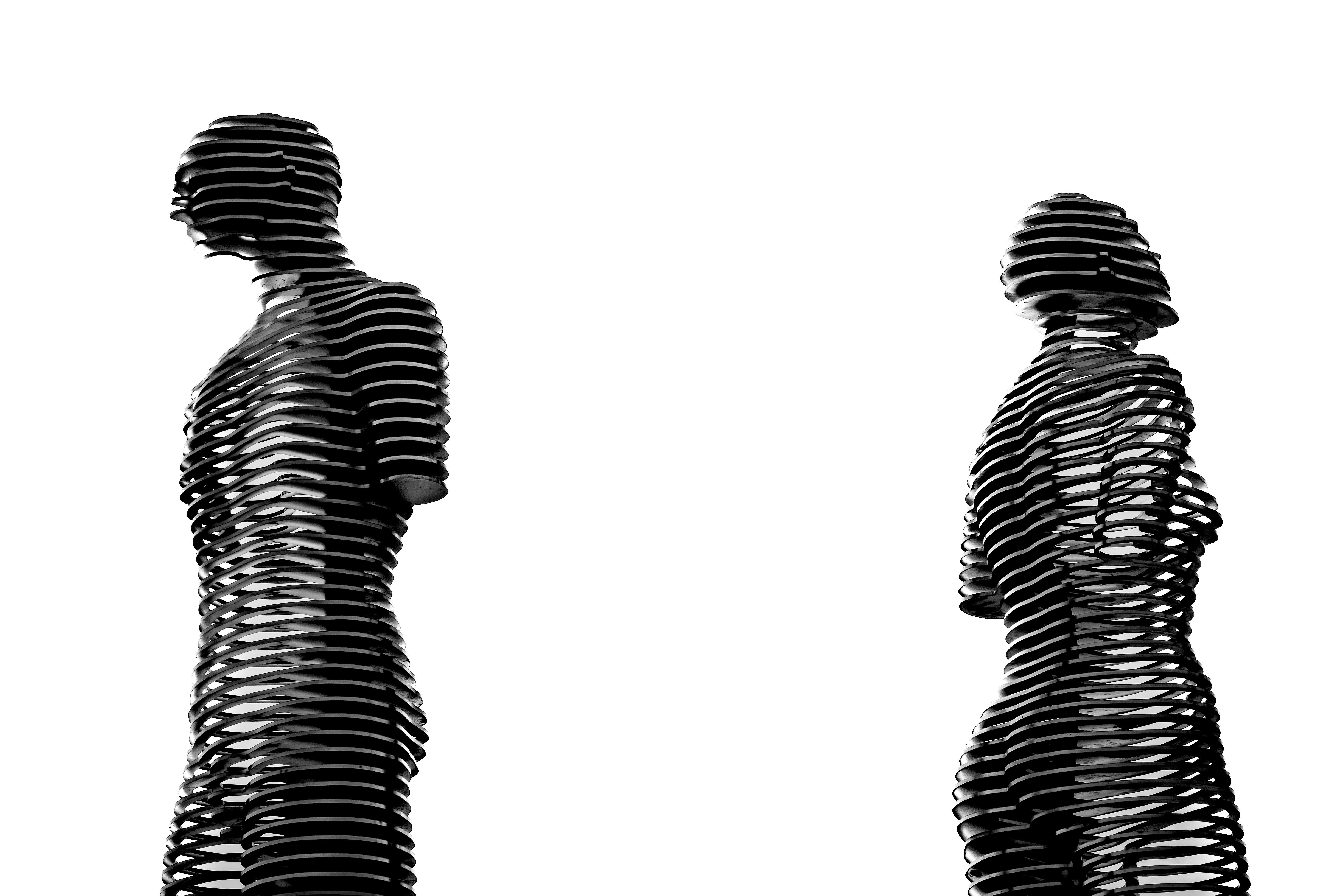 Two black and white images of two people standing next to each