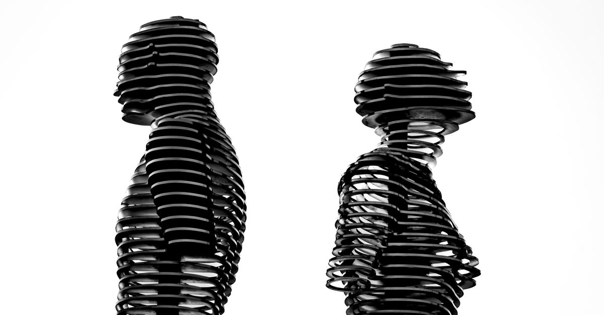 High-contrast abstract sculpture of two human figures in a silhouette form, conveying artistic expression.