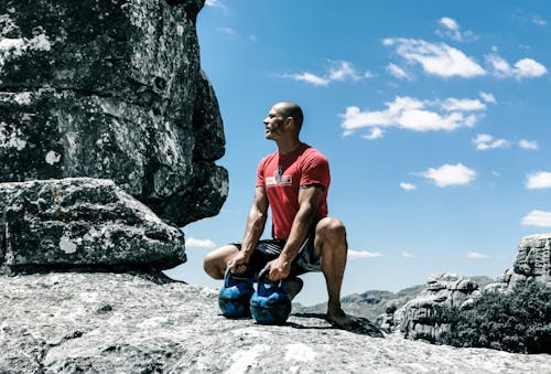 Man Holding Kettlebells