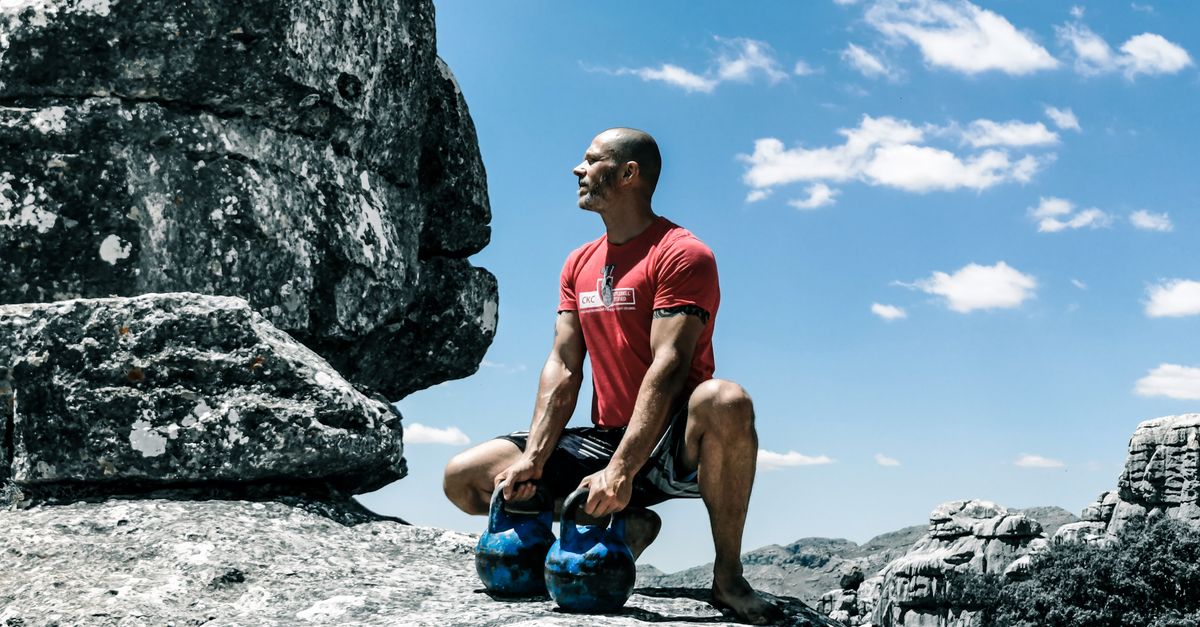person doing kettlebell swings with proper form outdoors