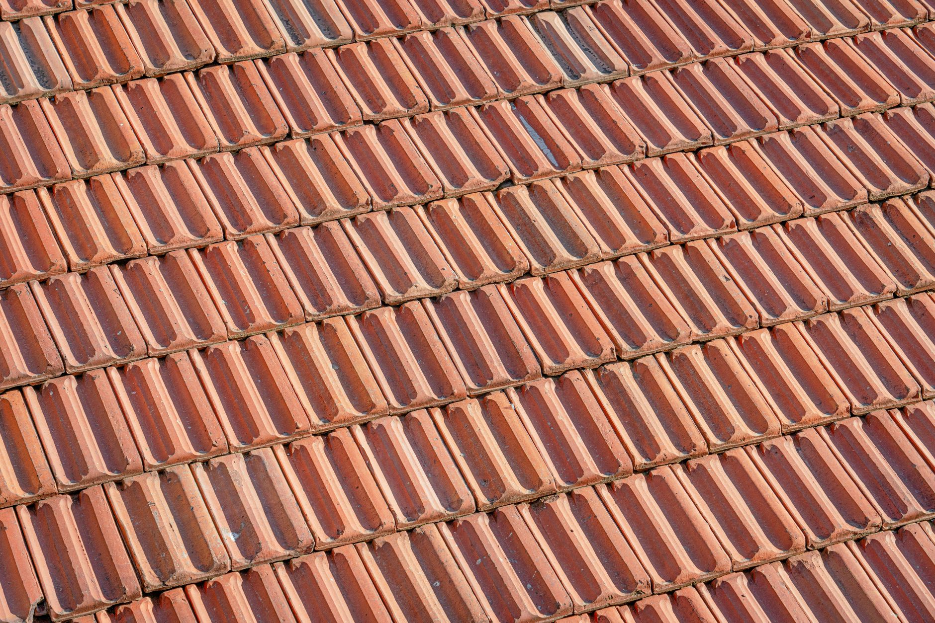 overlapping clay roof tiles displaying a classic repeating pattern