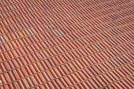 A red clay roof with a red tile pattern