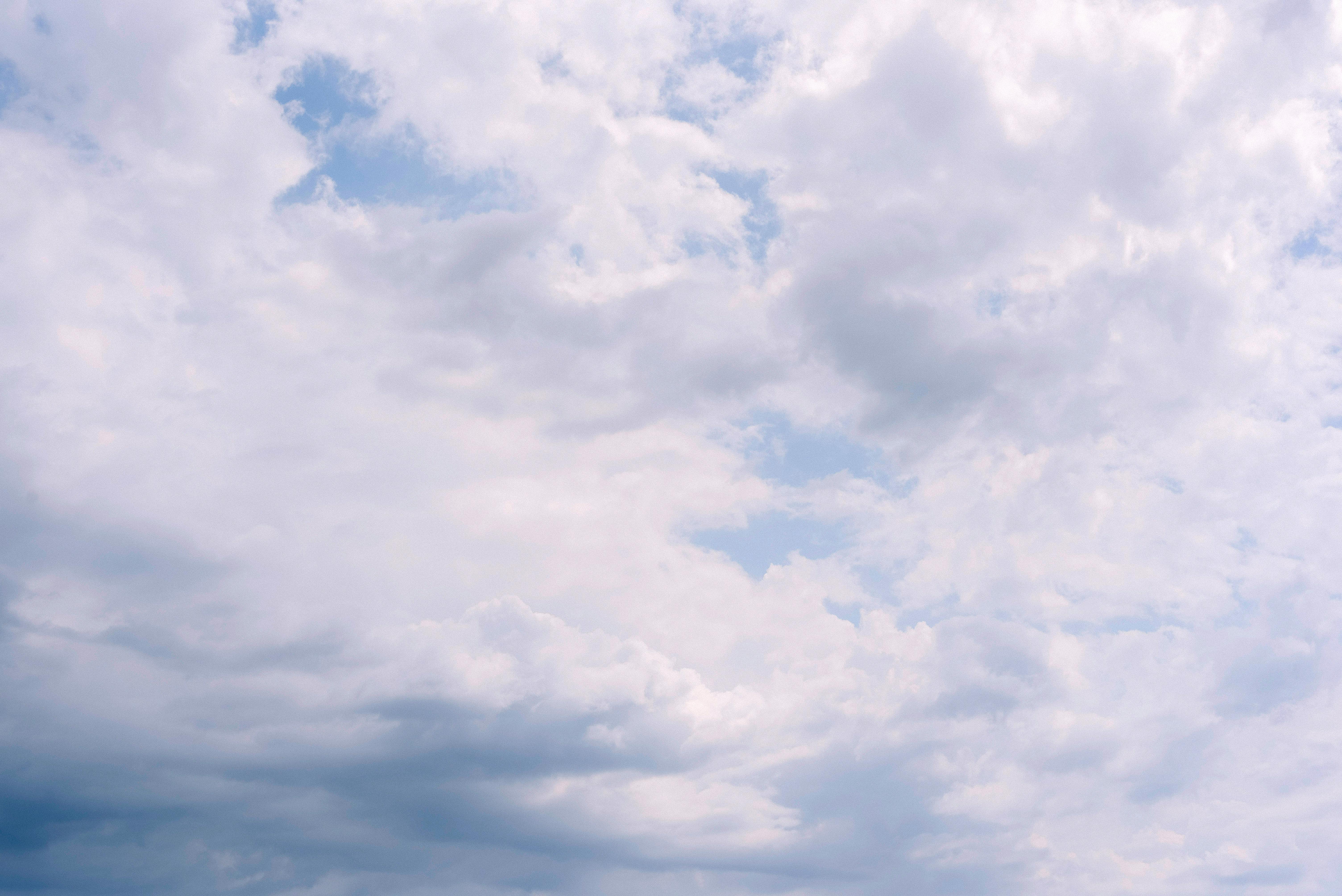 A bright overcast sky featuring fluffy clouds creating a serene atmosphere.
