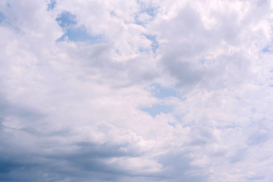 A bright overcast sky featuring fluffy clouds creating a serene atmosphere.