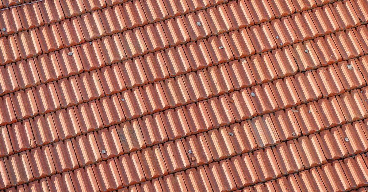 Detailed view of red clay roof shingles showcasing overlapping pattern and texture.