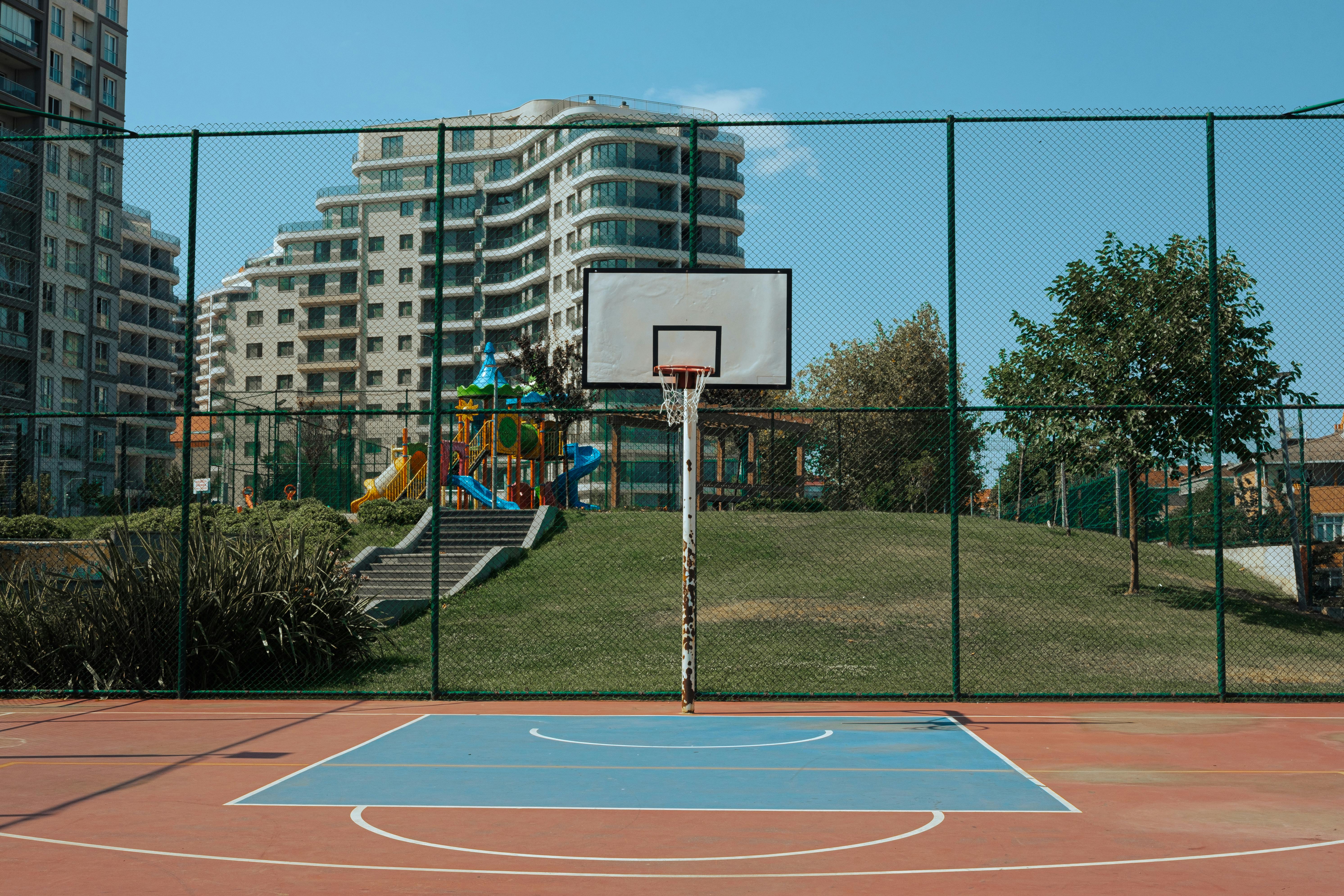 a basketball court with a fence in front of it