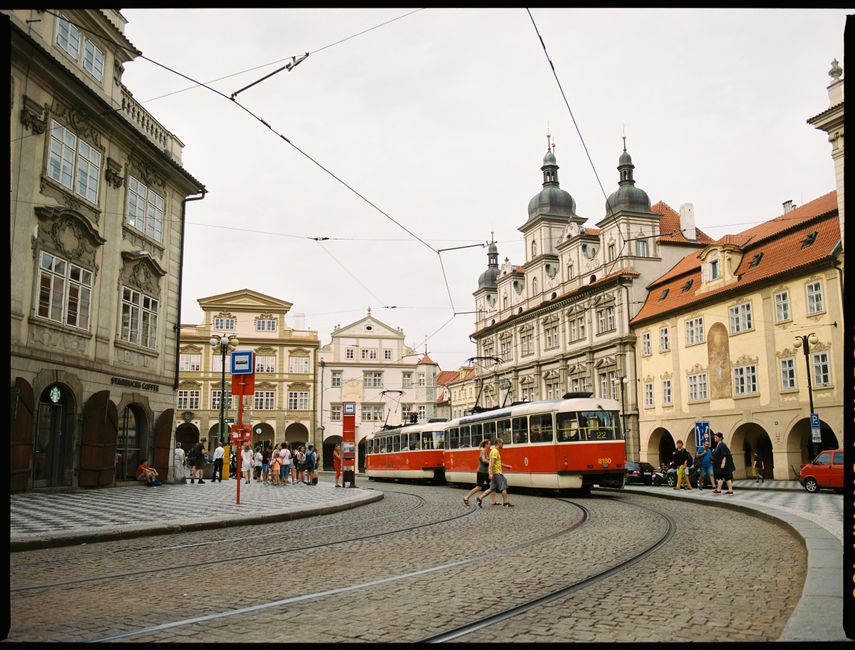 Cobbled town square with vintage tram and historic buildings, a blend of travel and urban charm.