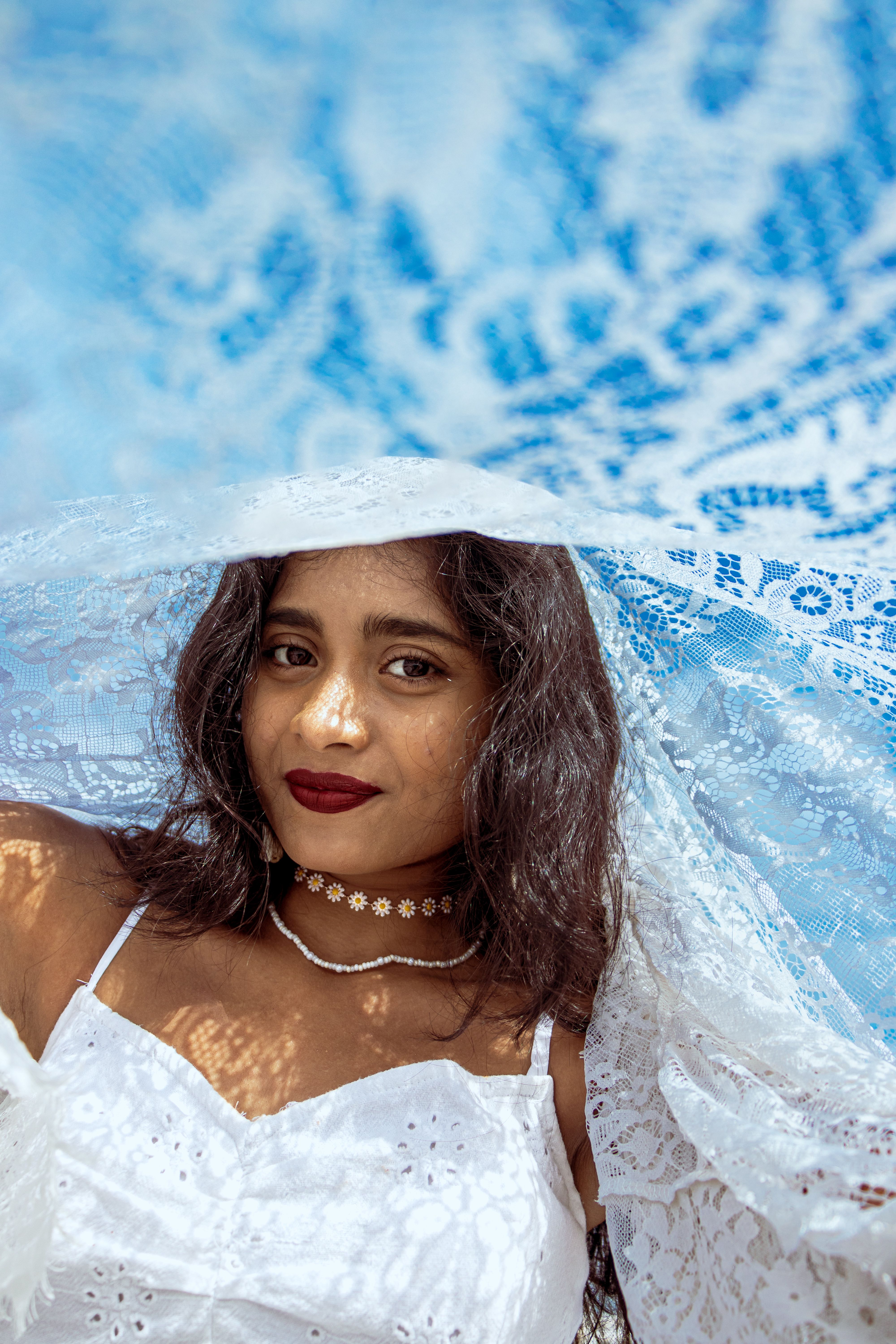 A woman in white dress and veil posing for a photo · Free Stock Photo