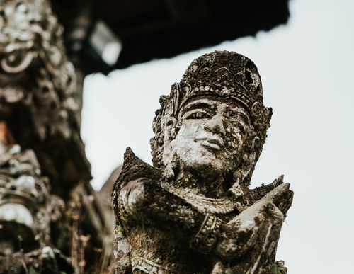 Free Ancient Balinese stone statue depicting cultural artistry in a temple. Stock Photo