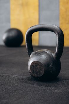 Rusty kettlebell on gym floor with blurred background. Perfect for fitness themes.