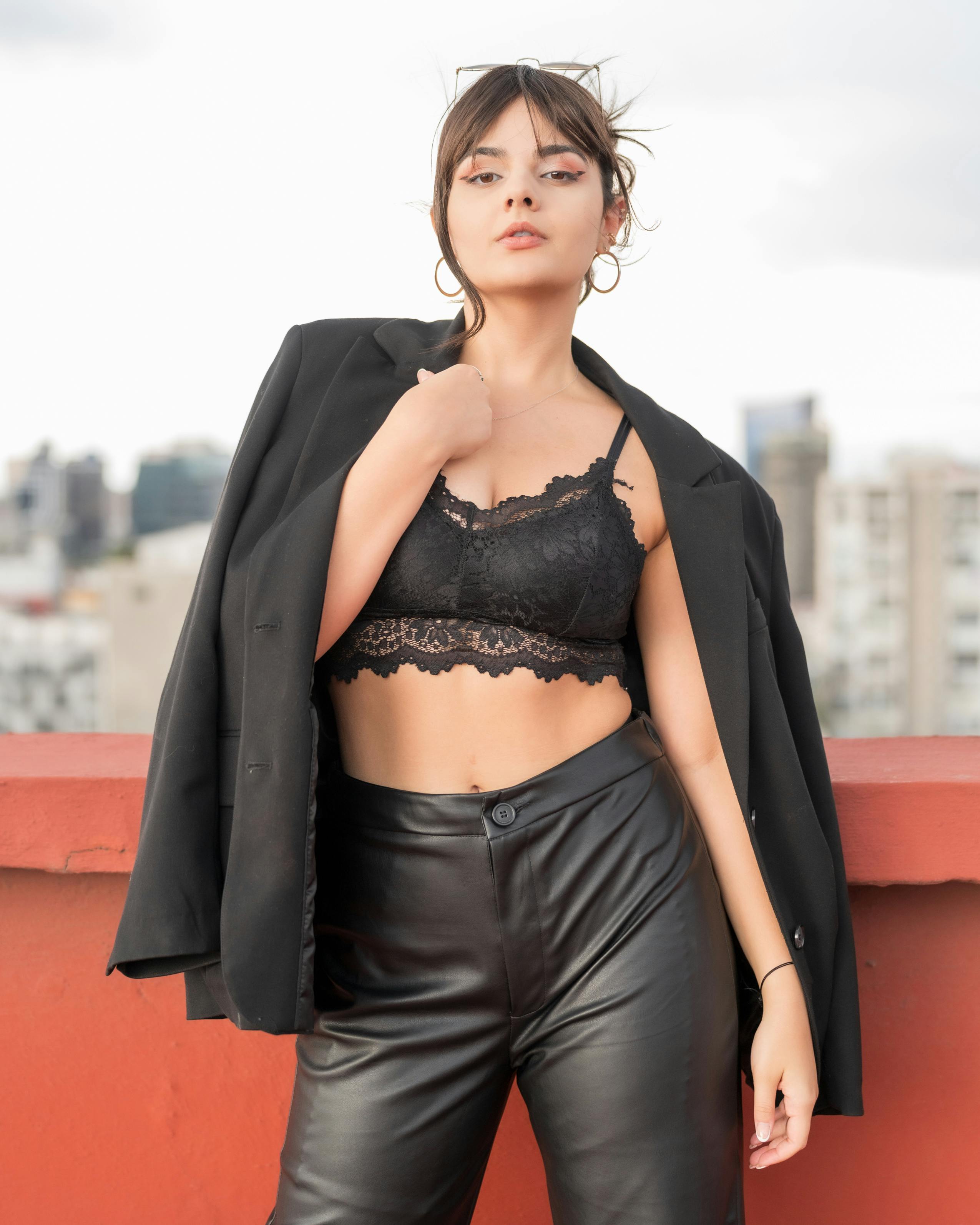 a woman in leather pants and a black bra top