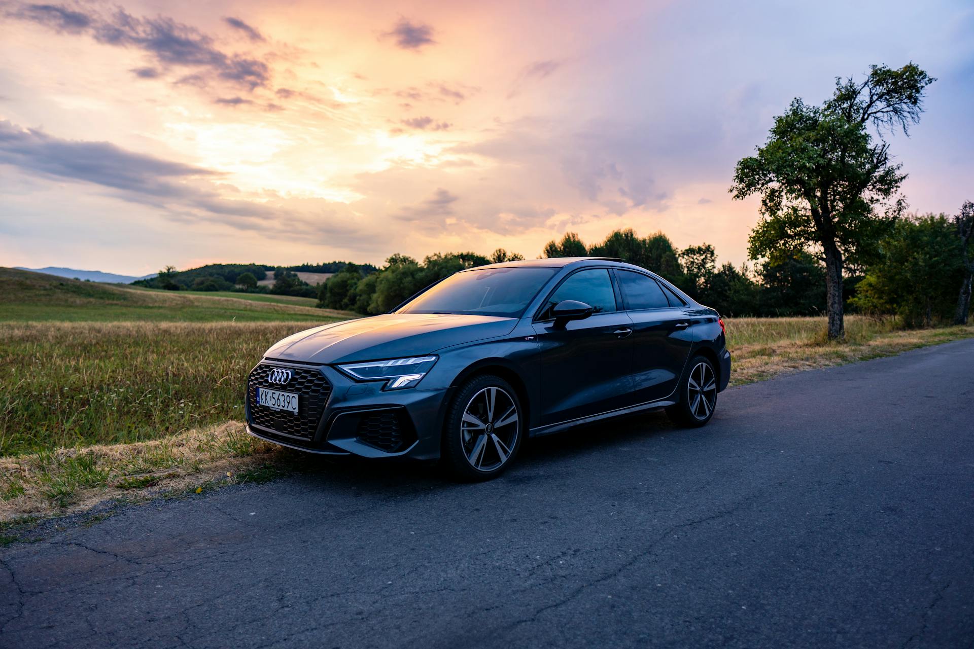 The audi s3 sedan parked on a road at sunset