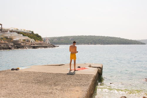 Photo of Man Standing Near Body of Water