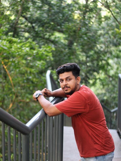 Free A young man enjoys a relaxing moment in the lush greenery of Nilambur Forest in Kerala, India. Stock Photo