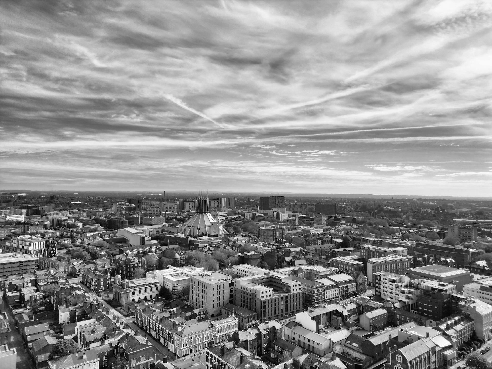 Aerial view of Liverpool showcasing urban skyline and architecture in black and white.