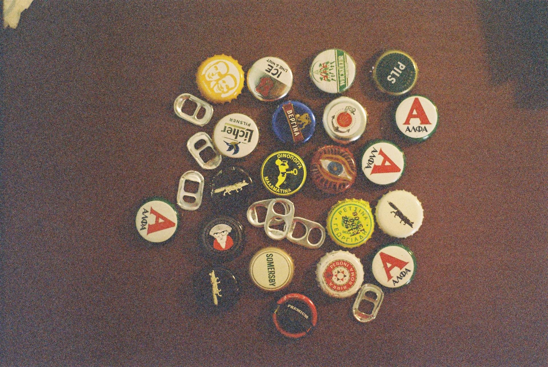 A nostalgic assortment of vintage bottle caps and pull tabs on a wooden table.