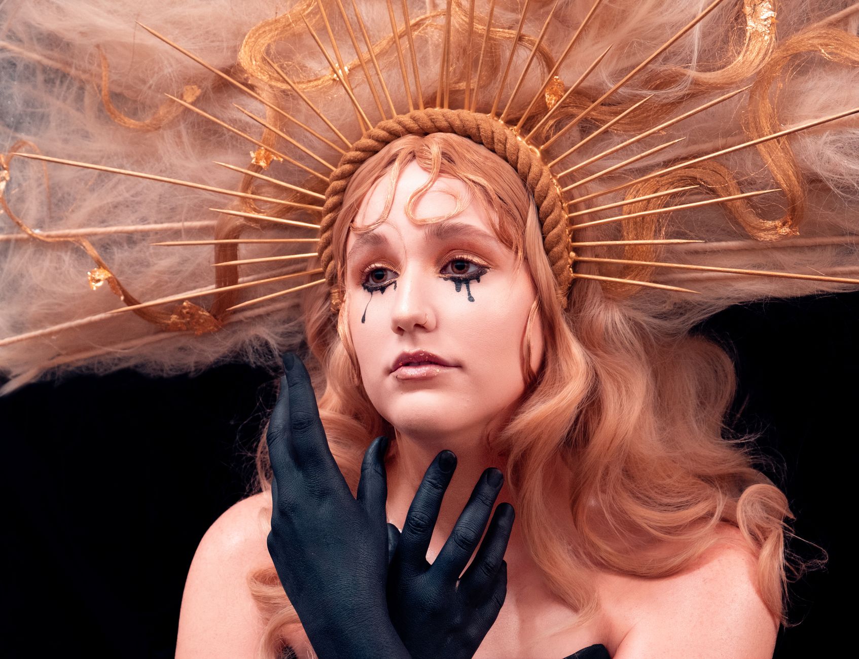 Ethereal portrait of a woman with artistic makeup and elaborate crown. Perfect for fantasy themes.
