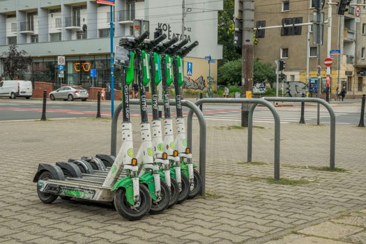 Lime electric scooters parked in Wrocław city center for urban transportation.