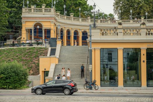 A vibrant street scene depicting daily activity near historical architecture in Wrocław, Poland.
