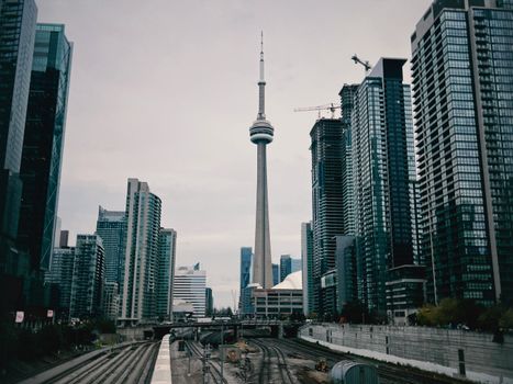 Iconic view of Toronto's skyline featuring the CN Tower among modern skyscrapers and urban architecture.
