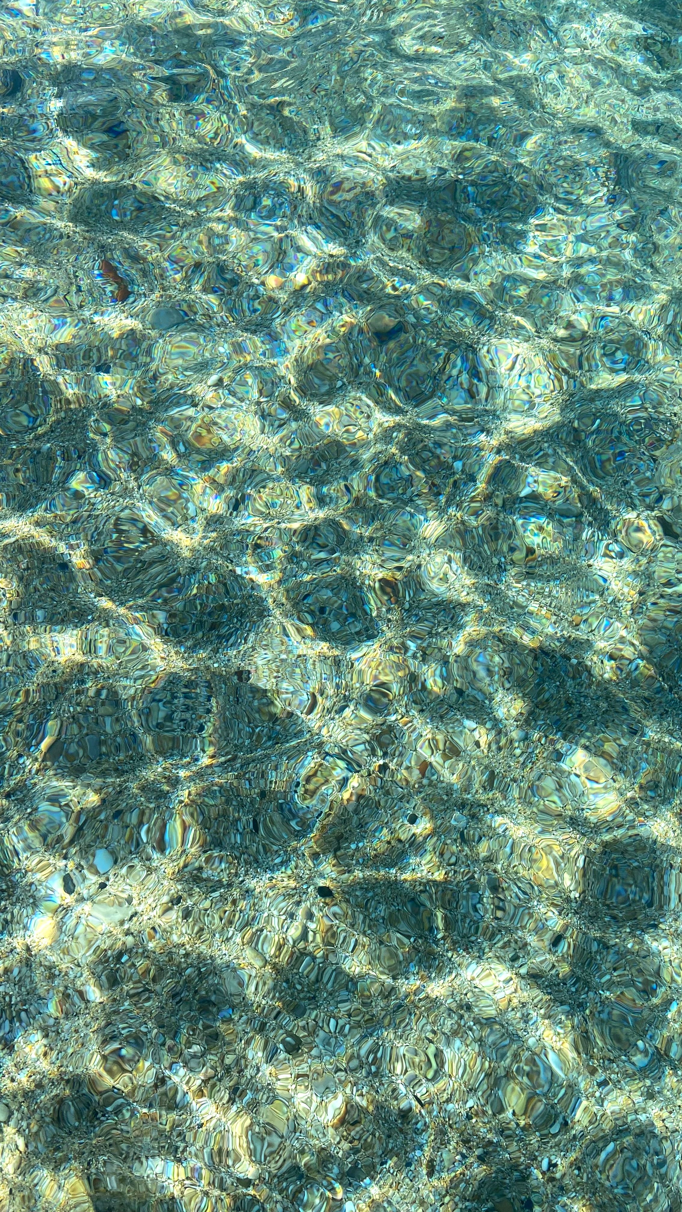 Beautiful turquoise water with sunlit ripples creating a mesmerizing pattern.