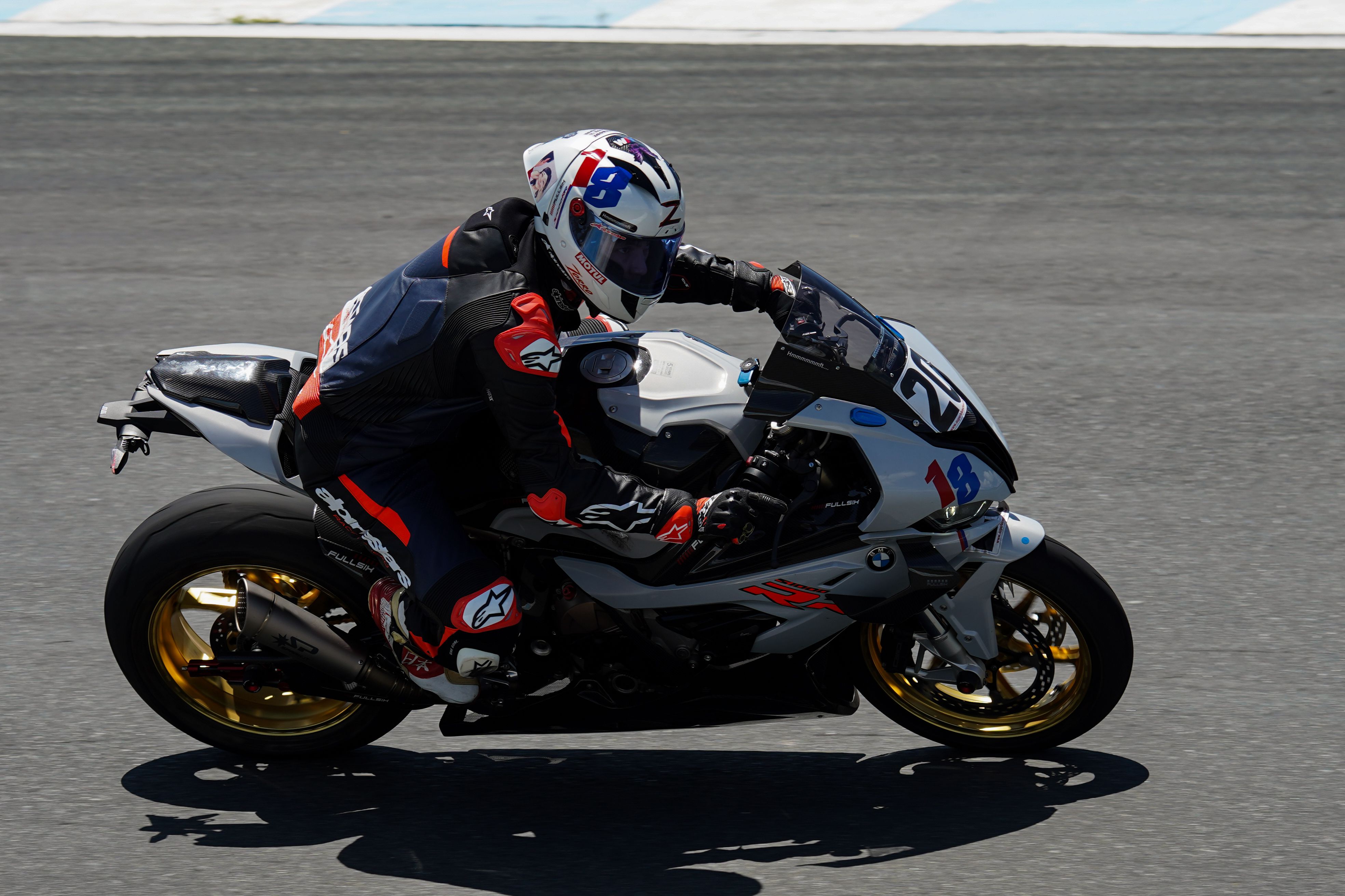 A person riding a motorcycle on a race track · Free Stock Photo