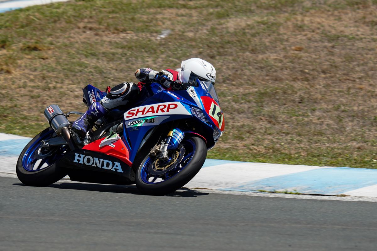 Motorcycle racer leaning through a circuit corner