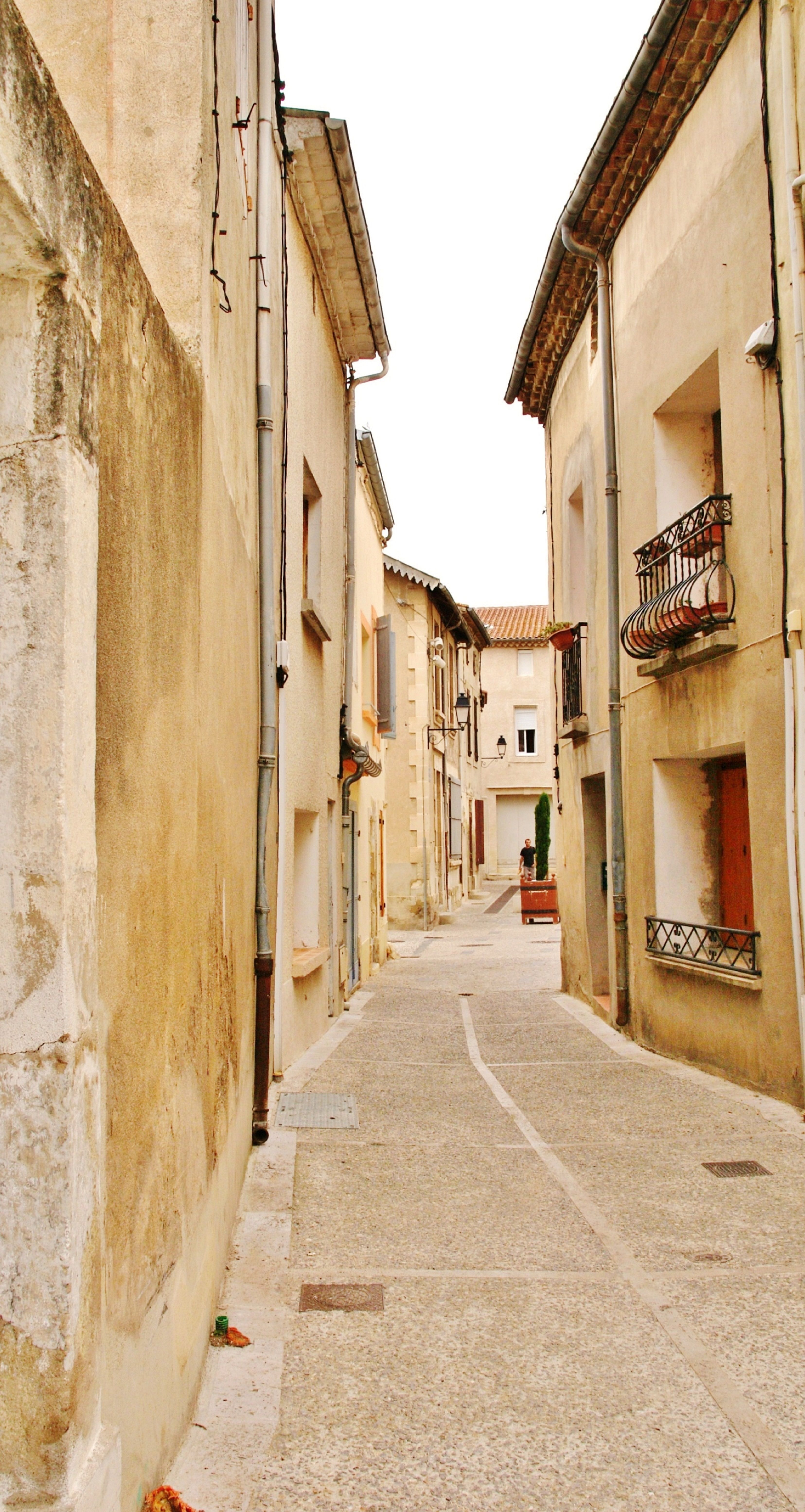 Explore the narrow cobblestone streets of Lespignan with historic Gothic architecture.